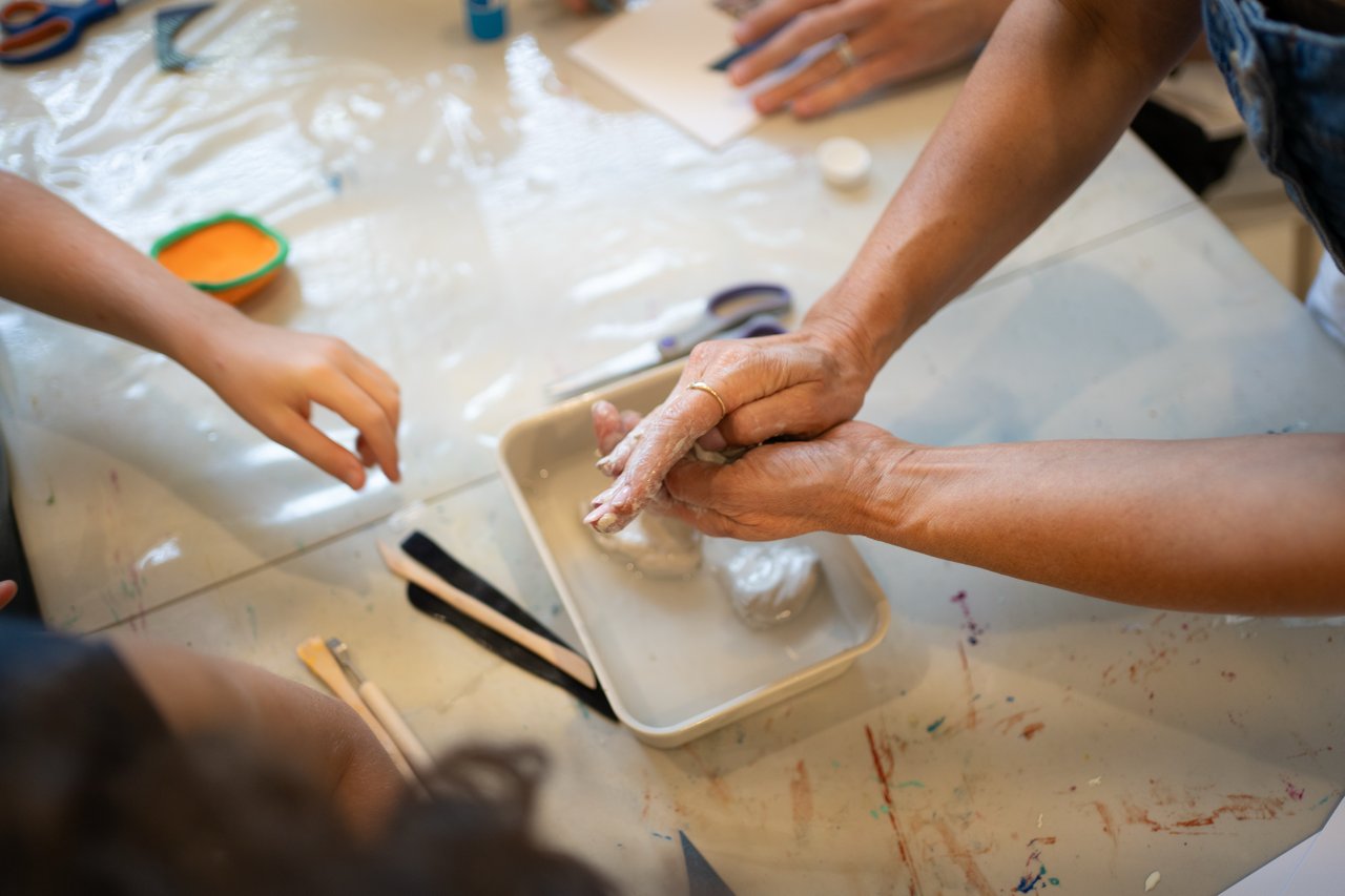 Hands exploring texture together during a group session